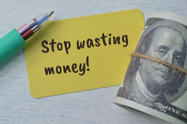 Pen Money Banknotes And Yellow Card With Text Stop Wasting Money ... for Stop Wasting Money on Premium Converters When Full Desks Cost Less